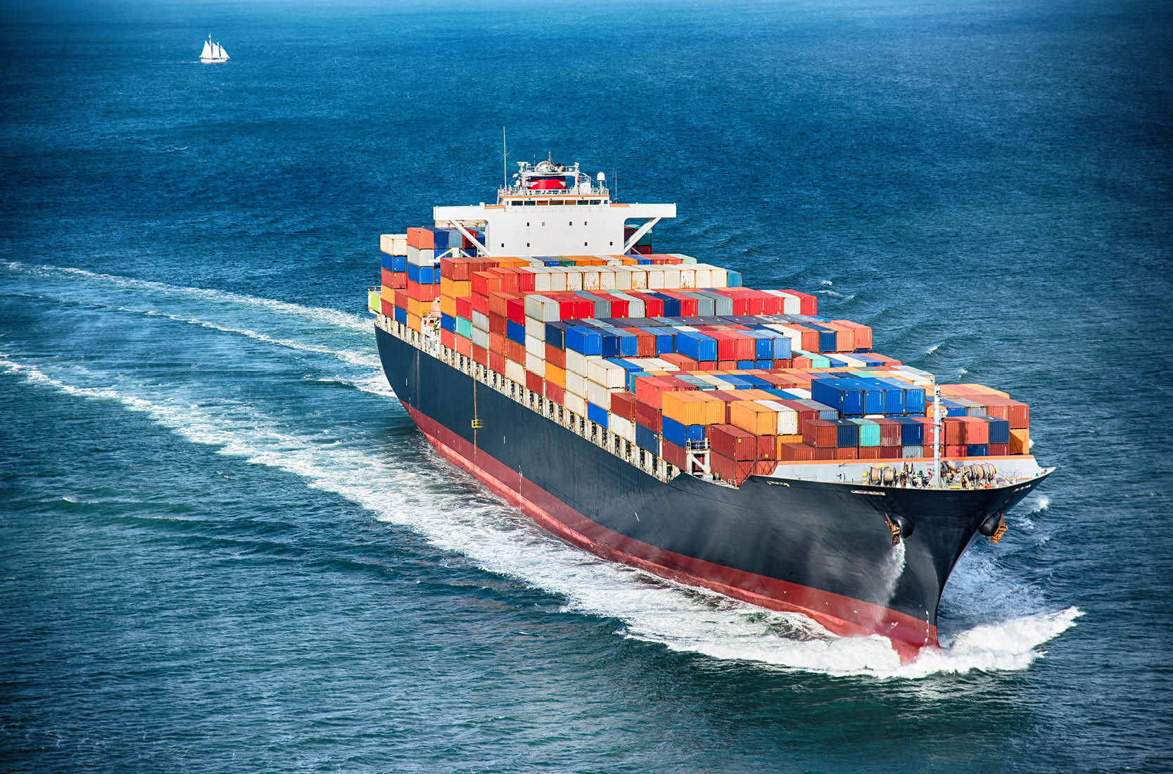 Barge with shipping containers in water.