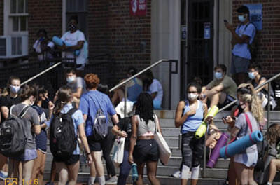 University of North Caroline at Chapel Hill students wait outside of Wollen Gymnasium for a class to begin