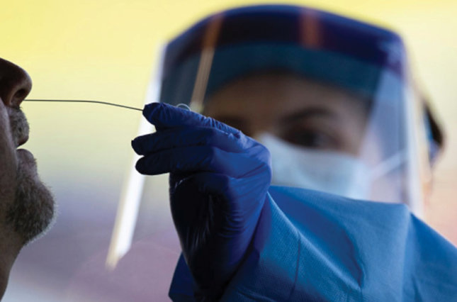 Healthcare worker administers a coronavirus nose swab test