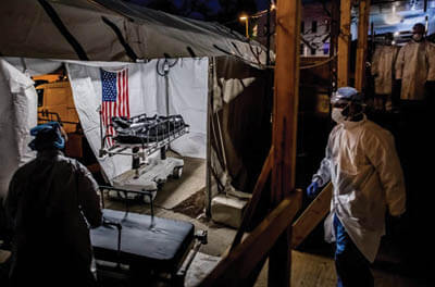 The transport team moves the body bags of deceased COVID-19 patients from the overflowing morgue of Brooklyn's Wyckoff Heights Medical Center into the improvised morgue set up outside on April 27