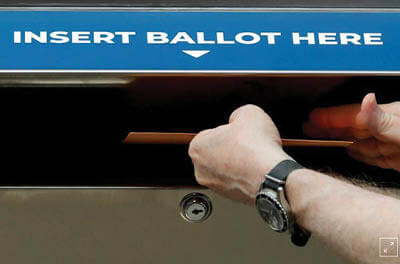 Man placing mail-in ballot in mailbox