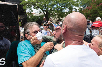 Paul Benson, attending a rally for Democratic candidate Hank Gilbert in Tyler, Tex., is attacked by Blue Lives Matter protesters on July 26