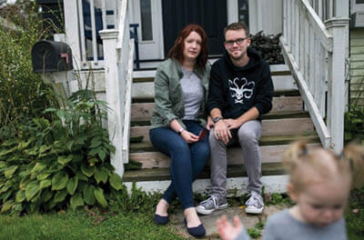 Shelby Parker sits outside of her home with her husband Ben and daughter Abby in Cuyahoga Falls, Ohio on Oct. 3. Parker planned to get pregnant this year but is contemplating not trying for a second child at all now due to the coronavirus pandemic.