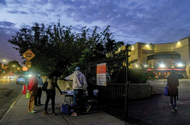 Volunteers outside the Christian Cultural Center in New York register new voters as part of the ‘Souls to the Polls’ initiative