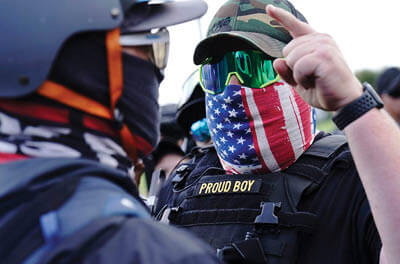 A right-wing demonstrator gestures toward a counterprotester as members of the Proud Boys and other right-wing demonstrators rally in Portland, Ore., Sept. 26.