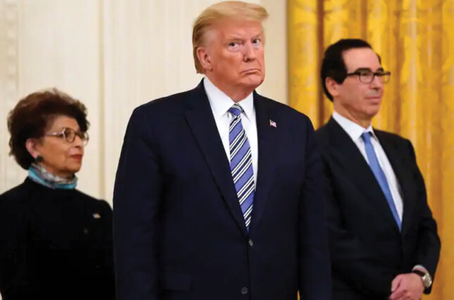 President Trump, along with Jovita Carranza, administrator of the Small Business Administration, and Treasury Secretary Steven Mnuchin, listens during an event in April about the Paycheck Protection Program