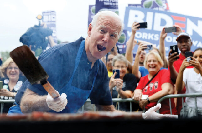 Joe Biden cooking on a grill at a 2020 campaign rally