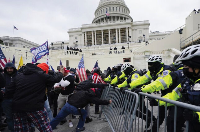 Capitol police try to keep protestors from breeching a barrier on January 6, 2020