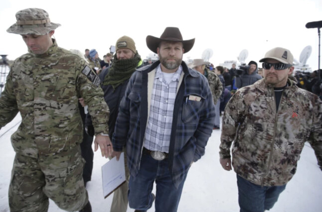 Men walk amid reporters