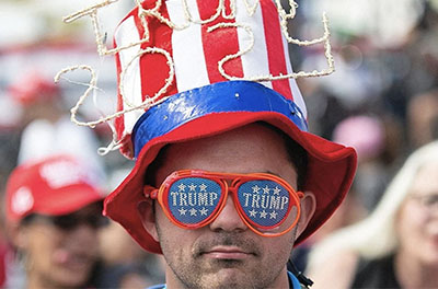 Man wearing Trump 2024 hat and Trump sunglasses