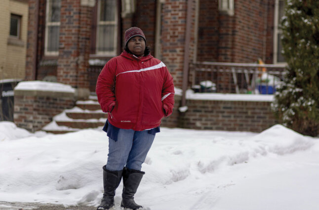 Woman stands in snow