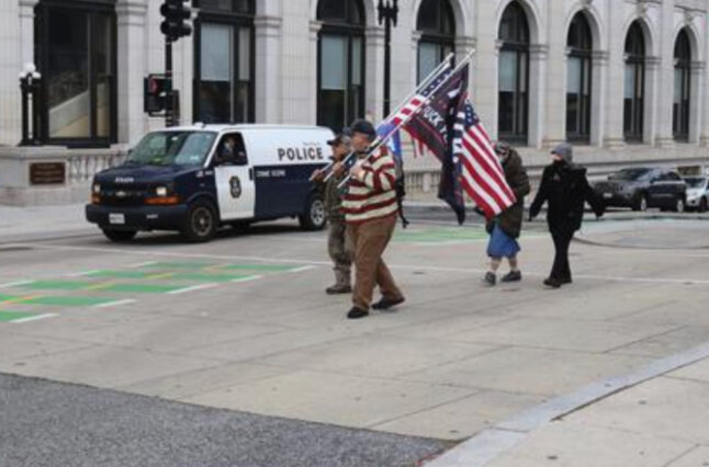 Men march with flags