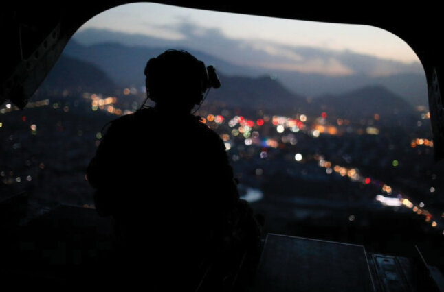 Man looking out of the back of a plane