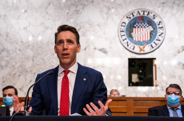 Man in suit gives speech