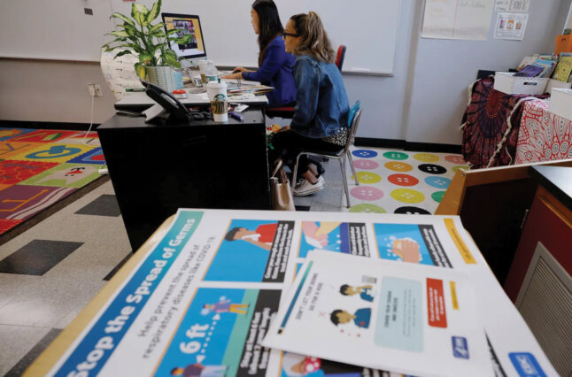 Teachers sit at desk