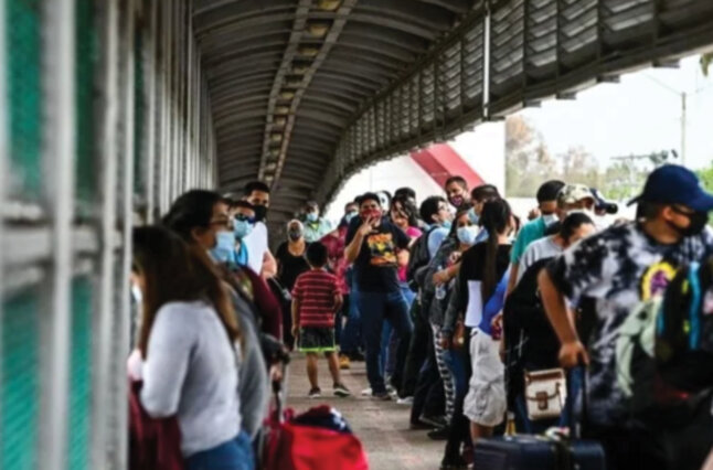 People stand at train stop