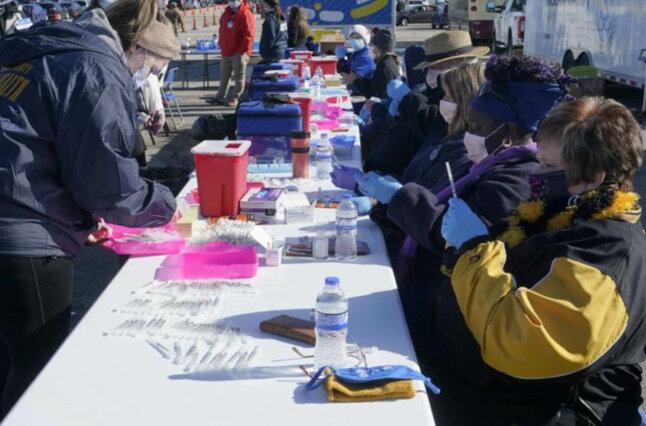 Photo of healthcare workers at a vaccine site