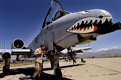 Staff Sergeant Keith Haas of the U.S. Air Force adjusts equipment on a A-10 Warthog warplane at Bagram Air Base.