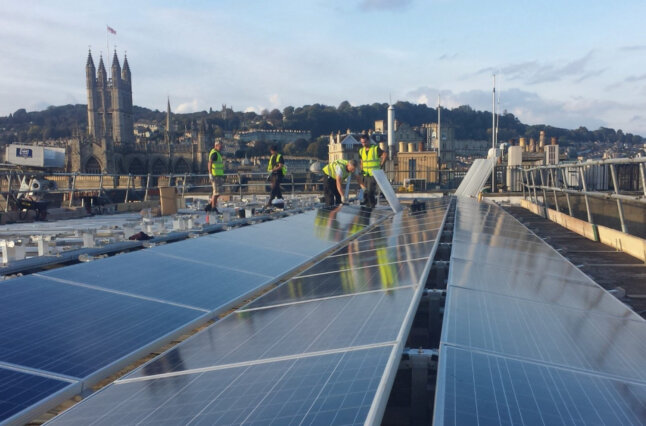 Workers instal Solar Panels