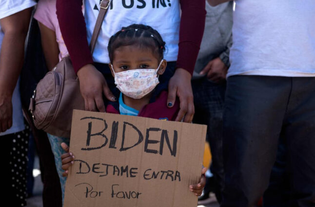 Girl stands with sign