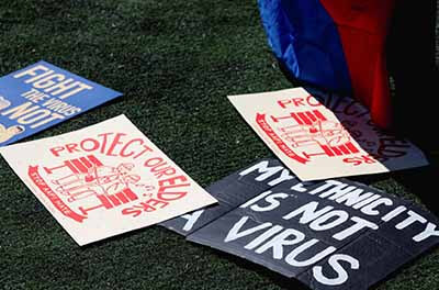 Signs spread on the ground at a rally to end Asian American hate in New York City in March 2021