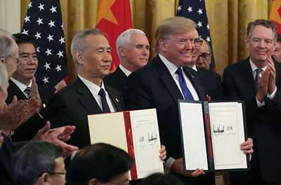 Donald Trump and Chinese Vice Premier Liu He hold up signed agreements of of a trade deal between the U.S. and China on January 15, 2020 in Washington, D.C.