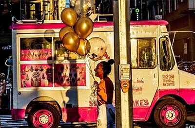 Woman carrying balloons