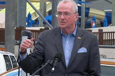 New Jersey Gov. Phil Murphy speaks at a news conference in a parking lot in Seaside Heights, New Jersey, on July 9, 2021, where four electric vehicle charging stations were recently installed.