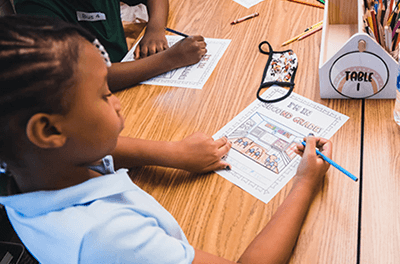 Young student writing an assignment at Marrietta City School.