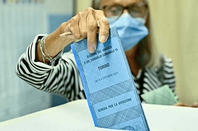 A woman votes at a polling station on Oct. 4, 2021, in Turin, Italy.