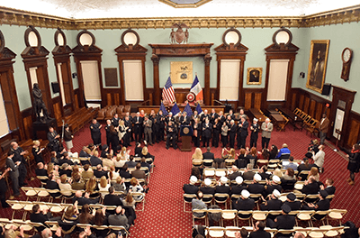 Photo of New York City council chamber with a statue of Thomas Jefferson