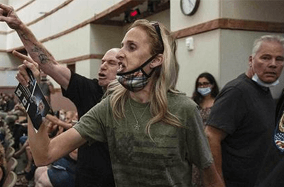 Graphic image of protesters at a school board meeting