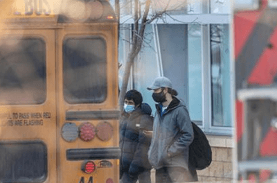 Image of school children waiting for school bus