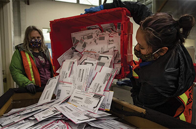 Graphic image of Oregon election workers process mail-in ballots on Nov. 3, 2020.