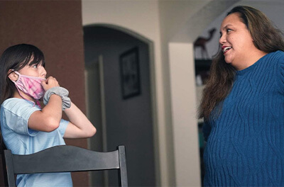 Graphic image of a mother talking with her daughter about schoolwork in their home