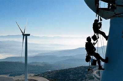 Workers climbing a wind turbine