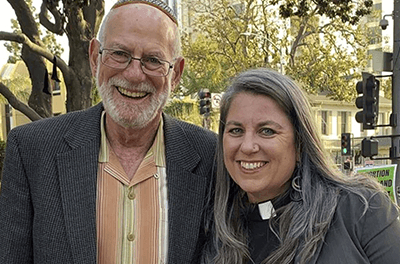 Rabbi Stephen Einstein, left, founding rabbi of Congregation B’nai Tzedek in Fountain Valley, Calif., stands with the Rev. Sarah Halverson-Cano, senior pastor of Irvine United Congregational Church in Irvine, Calif., at a rally supporting abortion access, in Santa Ana, Calif.,