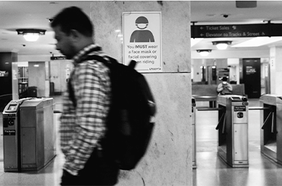 Photo of a man walking through a New York City subway station