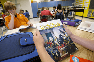 Eighth graders look over a new government book at West Sylvan Middle School in 2009 in Portland, Oregon