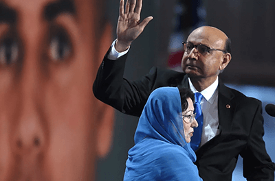 Khizr Khan, father of Humayun S. M. Khan, who was killed while serving in Iraq with the US Army, waves as his wife looks on during the Democratic National Convention on July 28, 2016 in Philadelphia,