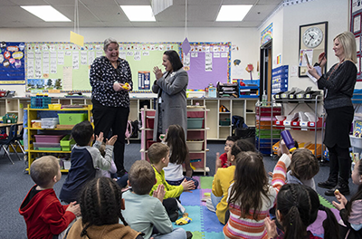 Kindergarten teacher is presented with an award from school district in Nevada.