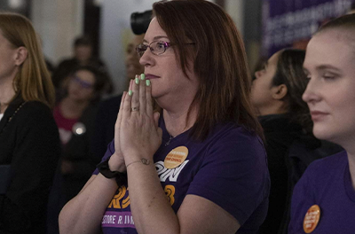 A supporter holds her breath on Election Day in November as preliminary results come in for a ballot measure that enshrined abortion rights in the Michigan Constitution.