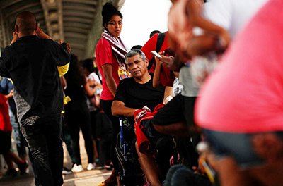 Migrants seeking asylum gather near a border crossing in Texas.