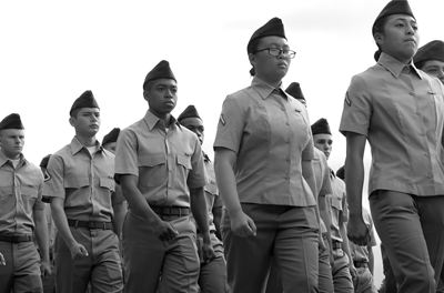 Photo of young military recruits marching in formation.