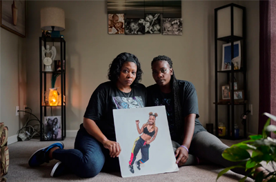 Kimberly Jones-Mbuyi, left, and KiAndrea Jones, Michaela Carter’s mother and sister, hold a photograph of Carter at their home in the Antioch neighborhood of Nashville, Tennessee.