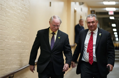 Rep. John Rutherford, R-Florida, and Rep. Don Bacon, R-Neb, walking in a hallway at the Capitol.