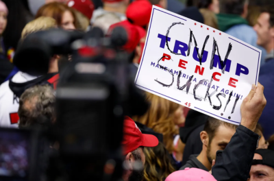 A Trump supporter holds a sign reading "CNN sucks" in 2018 in Fort Wayne, Indiana.