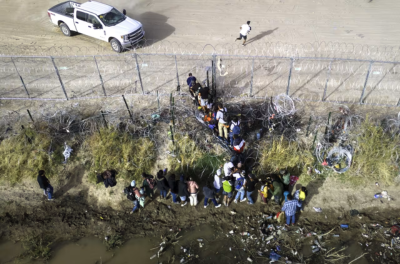 Migrants cross the U.S.-Mexico border in El Paso, Texas, March 13.