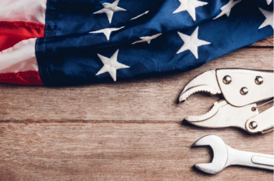 American flag and tools on wooden background